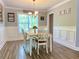 Cozy dining area with wood floors, wainscoting, natural light, and a modern light fixture at 148 Paradise Xing, Douglasville, GA 30134