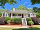Beautiful single-Gathering home showcasing a white porch, manicured front yard, and attractive landscaping at 148 Paradise Xing, Douglasville, GA 30134