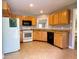 Well-lit kitchen with tile floors, granite countertops, and wood cabinets at 148 Paradise Xing, Douglasville, GA 30134