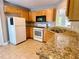Kitchen with granite countertops, wood cabinets, and tile floors at 148 Paradise Xing, Douglasville, GA 30134