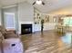 Spacious living room features wood floors, a cozy fireplace, and access to an adjacent dining area at 148 Paradise Xing, Douglasville, GA 30134