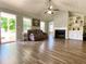 Living room featuring a fireplace, built-in shelves, wood floors, and natural light at 148 Paradise Xing, Douglasville, GA 30134
