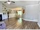 Open-concept living room with hardwood floors, a fireplace, and an adjacent dining area filled with natural light at 148 Paradise Xing, Douglasville, GA 30134