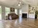Bright living room with neutral walls, hardwood floors, fireplace, and a view of the front yard at 148 Paradise Xing, Douglasville, GA 30134