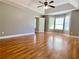 Spacious main bedroom featuring tray ceilings, hardwood floors, and a bright bay window at 148 Paradise Xing, Douglasville, GA 30134