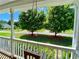 Relaxing view from the porch swing showing a tranquil neighborhood street and tree-lined front yard at 148 Paradise Xing, Douglasville, GA 30134