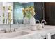 Bathroom featuring double sinks with marble countertops, flowers, and design-forward fixtures at 265 Tara Trl, Atlanta, GA 30327