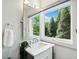 Well-lit bathroom boasts granite countertop, vanity, and natural light with scenic outdoor views at 265 Tara Trl, Atlanta, GA 30327