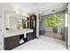 Modern bathroom featuring a double sink vanity, marble countertop, and glass-enclosed shower at 265 Tara Trl, Atlanta, GA 30327