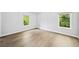A bright bedroom featuring hardwood floors, white walls, and natural light at 265 Tara Trl, Atlanta, GA 30327