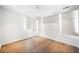 Hardwood floors and outdoor views bring natural light in this spacious bedroom with many windows at 265 Tara Trl, Atlanta, GA 30327