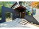 Modern home featuring a stylish entryway with concrete steps, a wood door, and an open-air architectural element at 265 Tara Trl, Atlanta, GA 30327