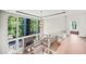 Bright hallway boasts a fireplace, hardwood floors, and a wall of large windows at 265 Tara Trl, Atlanta, GA 30327