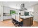Spacious kitchen featuring a large island with seating, stainless steel appliances, and natural light at 265 Tara Trl, Atlanta, GA 30327