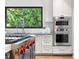 Gourmet kitchen boasts a professional range, double ovens, and bright natural light at 265 Tara Trl, Atlanta, GA 30327