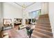 Open-concept living area with hardwood floors, staircase, stylish decor, and abundant natural light at 265 Tara Trl, Atlanta, GA 30327