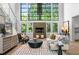 Bright living room with large windows, a cozy fireplace, hardwood floors, and contemporary furnishings at 265 Tara Trl, Atlanta, GA 30327