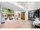 Spacious living room with high ceilings, a fireplace, large windows, and stylish decor creating an inviting atmosphere at 265 Tara Trl, Atlanta, GA 30327