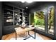 Beautiful office features built-in bookshelves, a ladder, and a large window with lush views at 265 Tara Trl, Atlanta, GA 30327