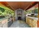 Outdoor kitchen with grill, pizza oven, and stone finishes, perfect for entertaining and culinary delights at 265 Tara Trl, Atlanta, GA 30327
