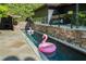 Modern pool with flamingo floats, stone accents, and sleek design for luxurious outdoor living at 265 Tara Trl, Atlanta, GA 30327