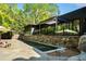 Backyard boasts a long, narrow pool, outdoor kitchen and privacy landscaping at 265 Tara Trl, Atlanta, GA 30327