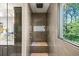 Modern shower featuring tiled walls and a built-in bench, with a view of the outside at 265 Tara Trl, Atlanta, GA 30327