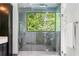 Contemporary shower with clear glass and a window overlooking lush greenery for a spa-like experience at 265 Tara Trl, Atlanta, GA 30327