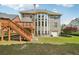 Backyard with deck, stairs, and lush green lawn at 2871 Trailing Ivy Way, Buford, GA 30519