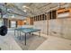 Unfinished basement with exposed ceiling and ping pong table at 2871 Trailing Ivy Way, Buford, GA 30519