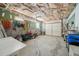 Unfinished basement with exposed ceiling, open garage, and lawn equipment at 2871 Trailing Ivy Way, Buford, GA 30519