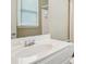 Bright bathroom featuring a white vanity with sink, a large mirror, and a window at 2871 Trailing Ivy Way, Buford, GA 30519