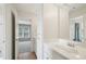 Bright bathroom featuring a vanity with a sink and mirror, with a view to the next room at 2871 Trailing Ivy Way, Buford, GA 30519