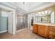 Well-lit bathroom showcasing a glass-enclosed shower and a vanity with a large mirror and ample counter space at 2871 Trailing Ivy Way, Buford, GA 30519