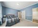 Serene blue bedroom with a comfortable bed, ample closet space, and attached bathroom access at 2871 Trailing Ivy Way, Buford, GA 30519