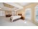 Spacious bedroom featuring a tray ceiling, ceiling fan, and two large windows providing natural light at 2871 Trailing Ivy Way, Buford, GA 30519