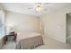 Simple bedroom with neutral walls, a window offering natural light, and a cozy carpet at 2871 Trailing Ivy Way, Buford, GA 30519