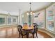 Cozy dining area with a round table, four chairs, and multiple windows providing natural light at 2871 Trailing Ivy Way, Buford, GA 30519