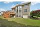 Back of home with well-manicured lawn, deck and lush landscaping at 2871 Trailing Ivy Way, Buford, GA 30519