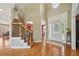 Stunning foyer with hardwood floors, staircase, and elegant doorway leading into the home at 2871 Trailing Ivy Way, Buford, GA 30519
