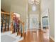 Elegant two-story foyer with hardwood floors, chandelier, and staircase with decorative iron railings at 2871 Trailing Ivy Way, Buford, GA 30519