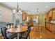 Charming eat-in kitchen featuring wood cabinets, granite countertops, stainless steel appliances, and hardwood floors at 2871 Trailing Ivy Way, Buford, GA 30519
