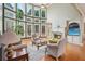 Bright and airy living room with expansive windows, hardwood floors, and a cozy fireplace at 2871 Trailing Ivy Way, Buford, GA 30519