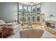 Large living room featuring floor to ceiling windows, fireplace, and hardwood floors at 2871 Trailing Ivy Way, Buford, GA 30519