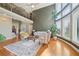 Cozy living room boasting a fireplace, large windows, hardwood floors, and a view of the upper level at 2871 Trailing Ivy Way, Buford, GA 30519