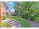 Lush backyard featuring a manicured lawn, stone pathway, and mature trees, creating a serene outdoor space at 980 Windsor Place Cir, Grayson, GA 30017