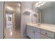 Bathroom featuring a white vanity, tile flooring, a large mirror, and access to another bathroom area at 980 Windsor Place Cir, Grayson, GA 30017