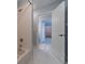 Bathroom boasting white tile, a tub/shower combo, and an open doorway leading to the walk-in closet at 980 Windsor Place Cir, Grayson, GA 30017