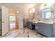 Beautiful bathroom featuring marble tiling, double vanities, and modern fixtures at 980 Windsor Place Cir, Grayson, GA 30017