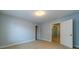 A bright bedroom featuring neutral carpet, pale-blue walls, and an open doorway at 980 Windsor Place Cir, Grayson, GA 30017